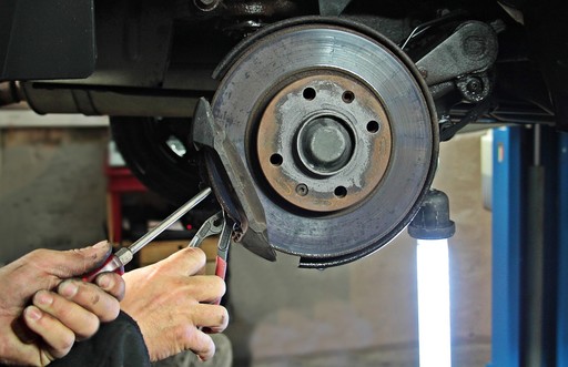 Man fixing vehicle brakes