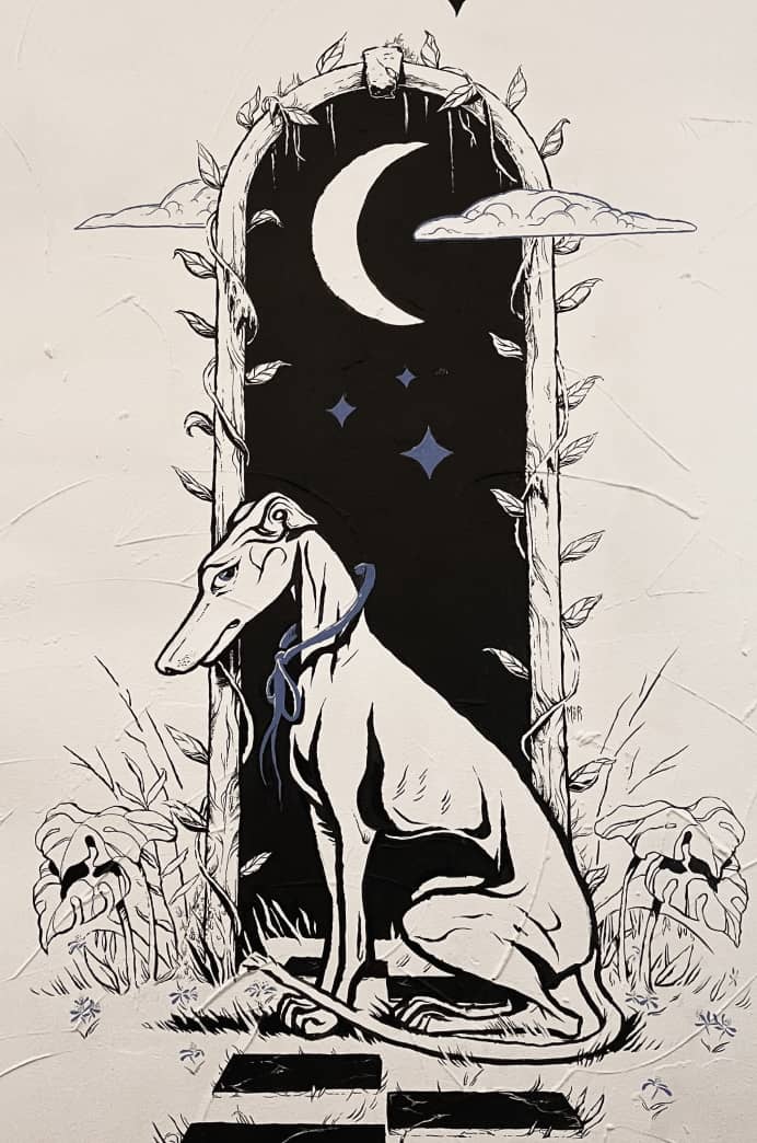 Black and white mural of whippit hound infront of metaphysical portal with stars and moon. Clouds, vegetation and worn tiles.