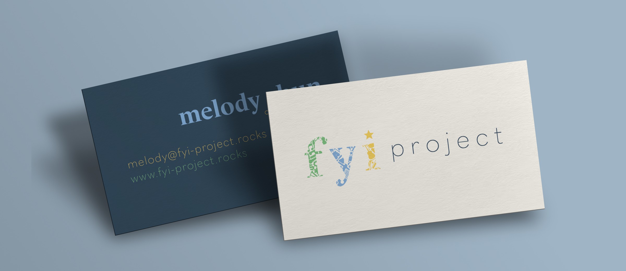 2 business cards, one showing the dark blue back with details and the other showing the lighter front side with logo.