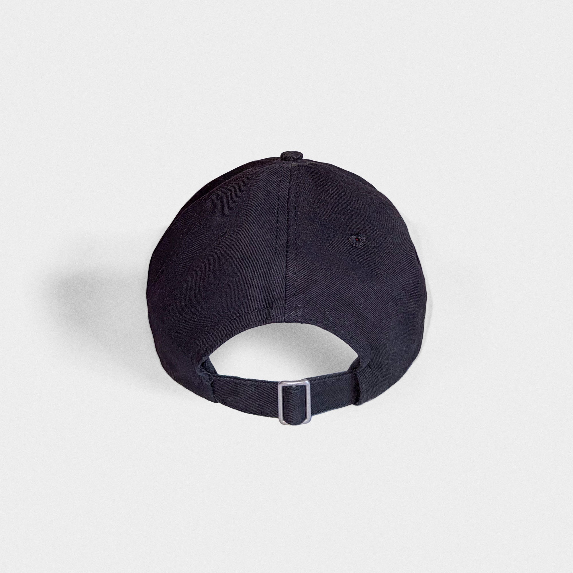 The back of a black baseball cap on a light gray background