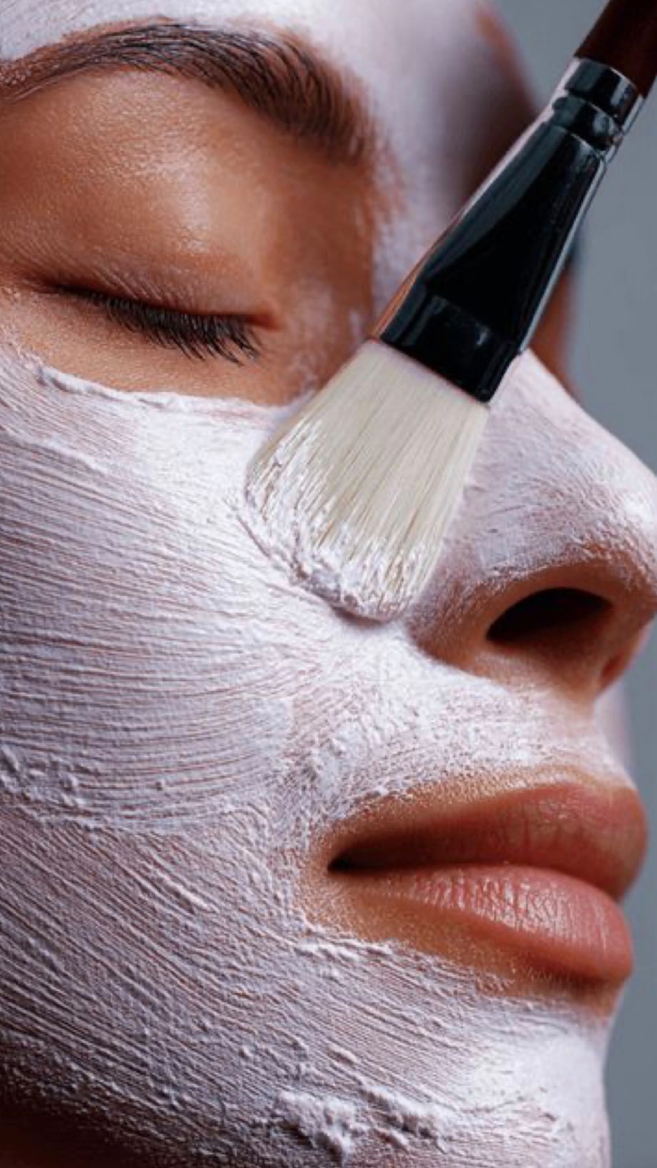 makeup model with green eyeshadow and dark nail polish