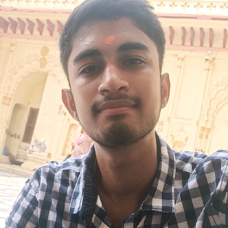 A Young woman in grey blueish background smiling