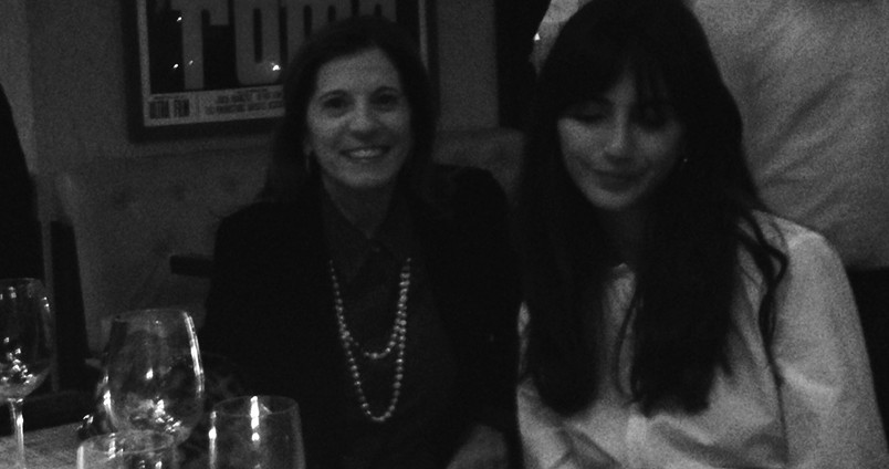 portrait of two women, and one is looking at the ground