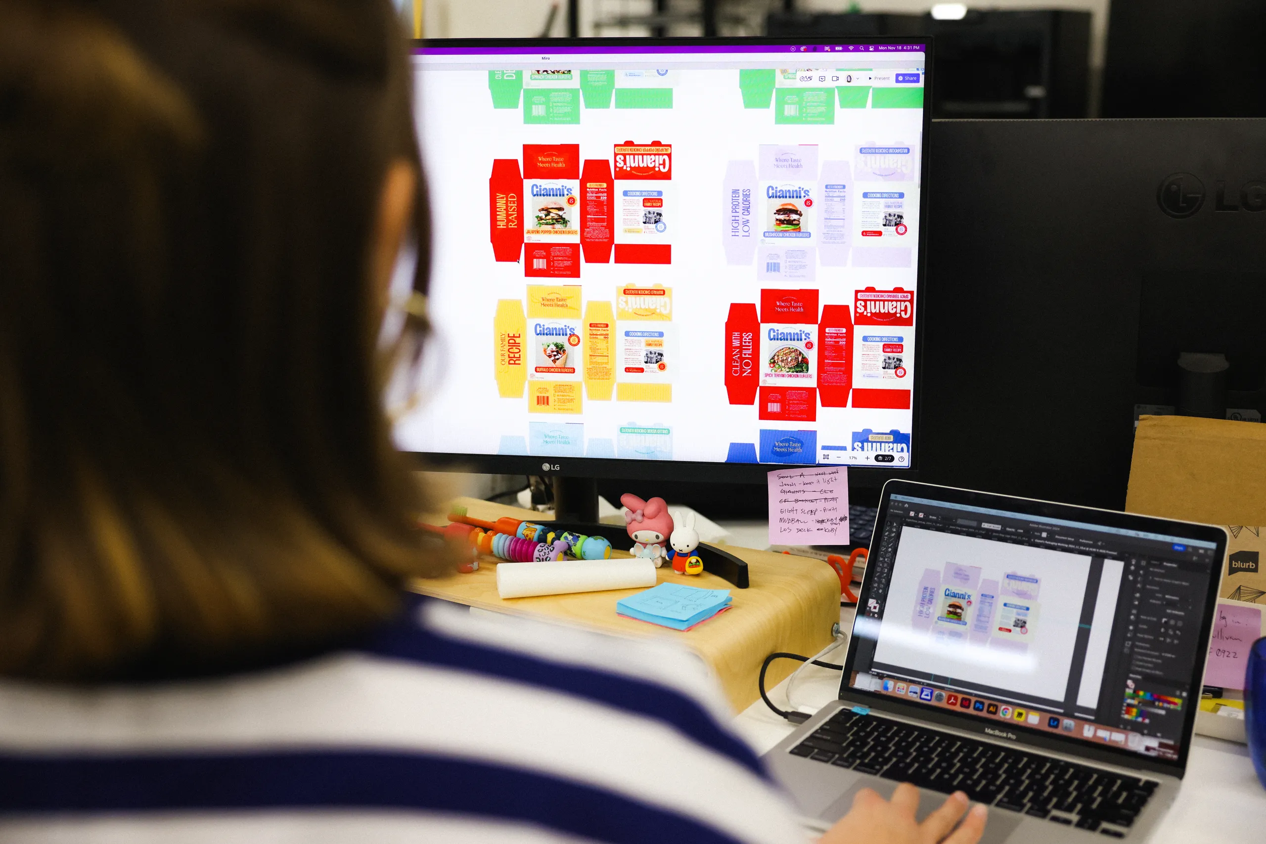 Designer reviewing packaging and product production files at Leadoff Studio