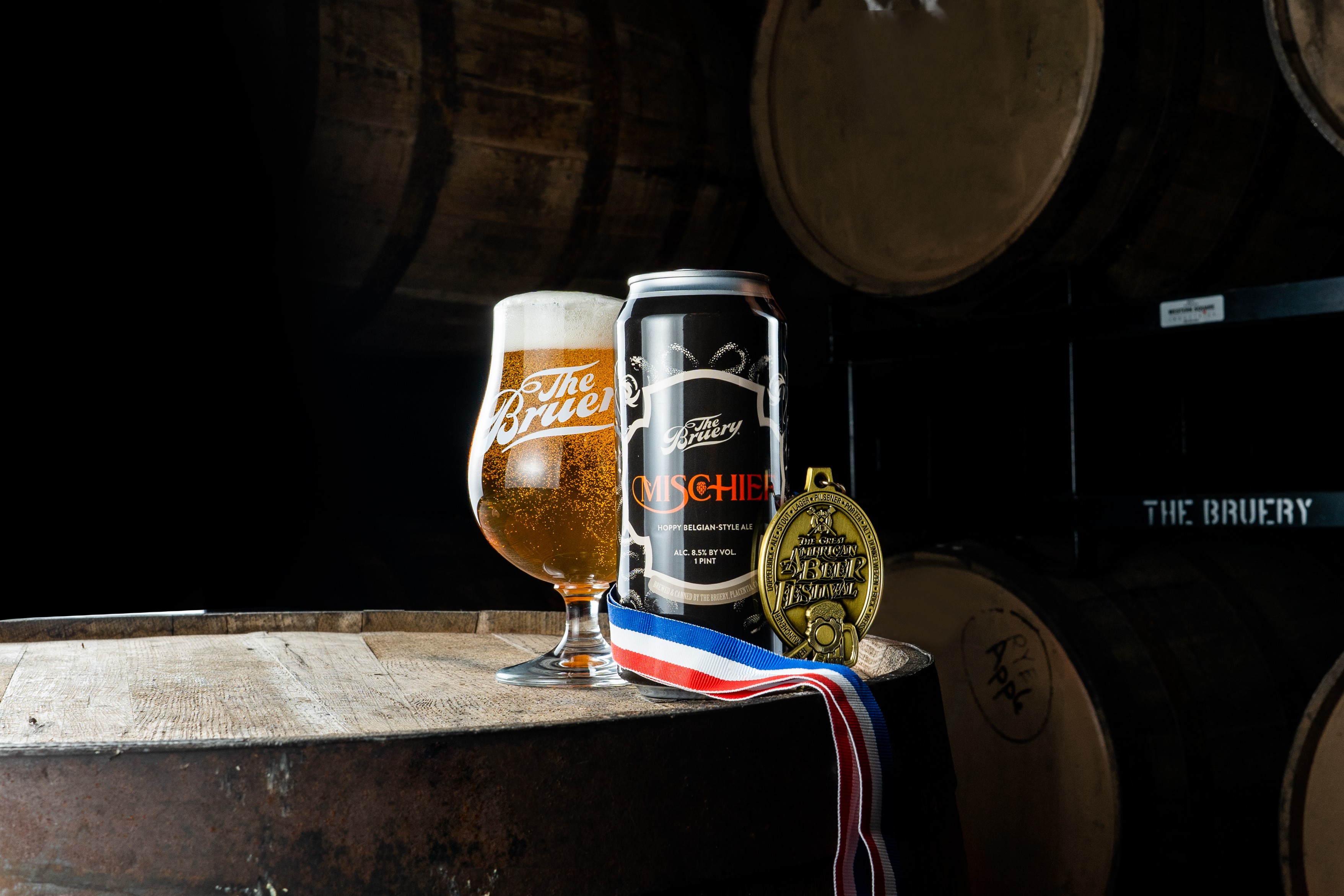 The Bruery barrel room with beer and medals on table
