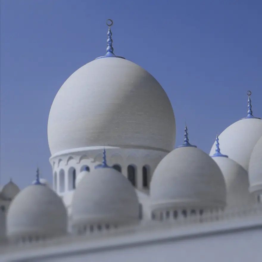 White domes against a clear blue sky, showcasing a blend of architectural styles and designs.