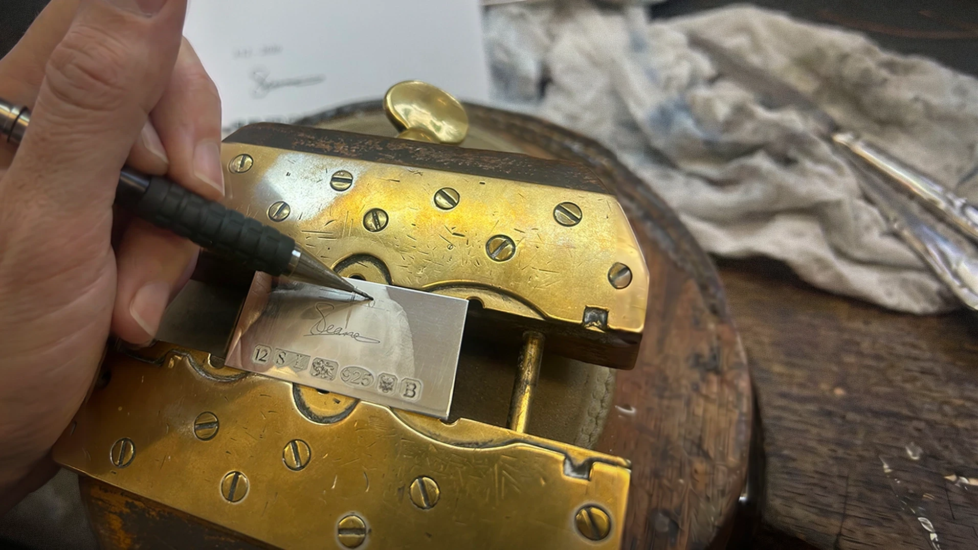 Engraver marking a signed metal plaque for a Shaun Leane 12 creation