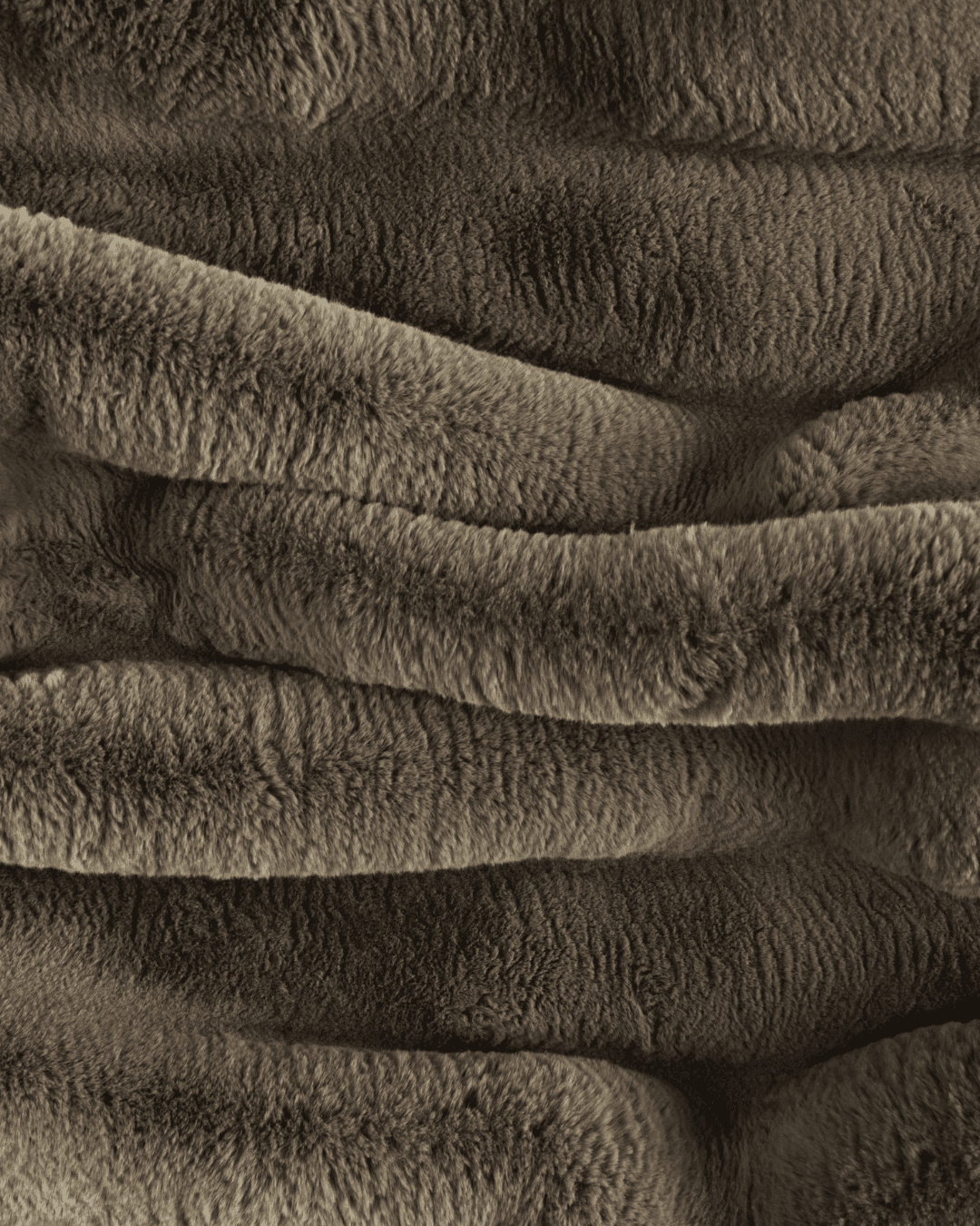 close up fabric shot of a dimensional faux fur blanket in fungi