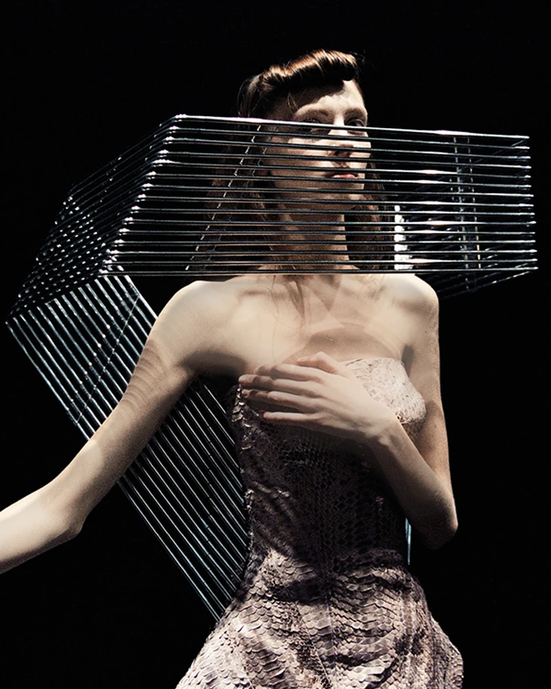Fashion model wearing the bespoke Grille Collar by Shaun Leane, a hand-forged aluminium visionary neckpiece constructed from 15 parallel tubes.