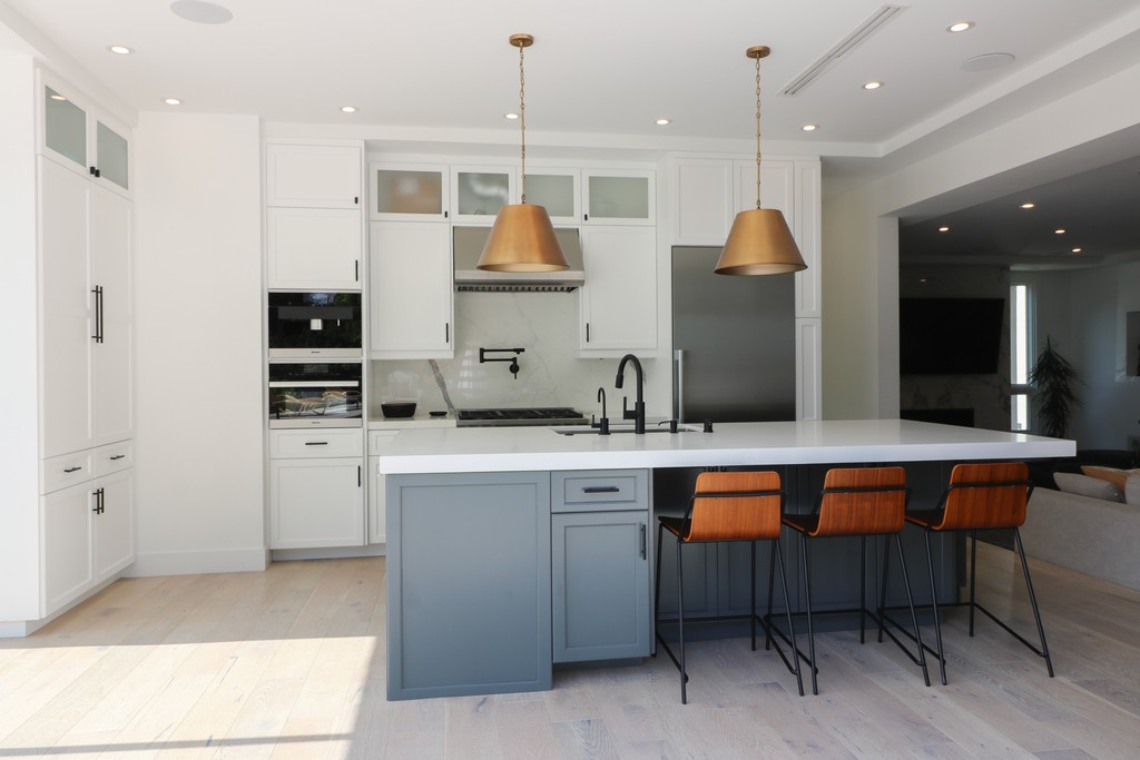 grey and white two tone shaker kitchen with black handles
