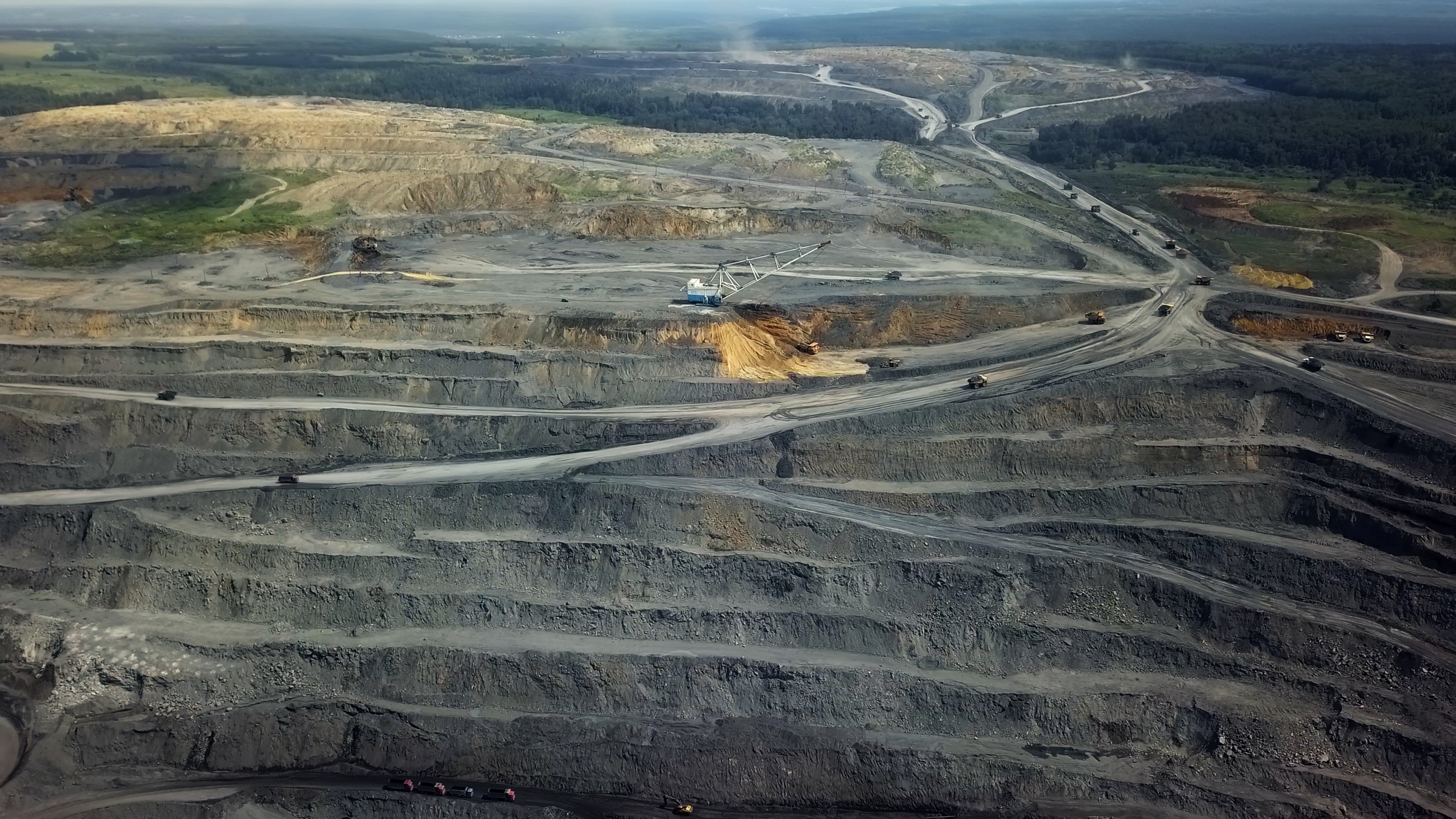 A fast black sports car races down the highway.