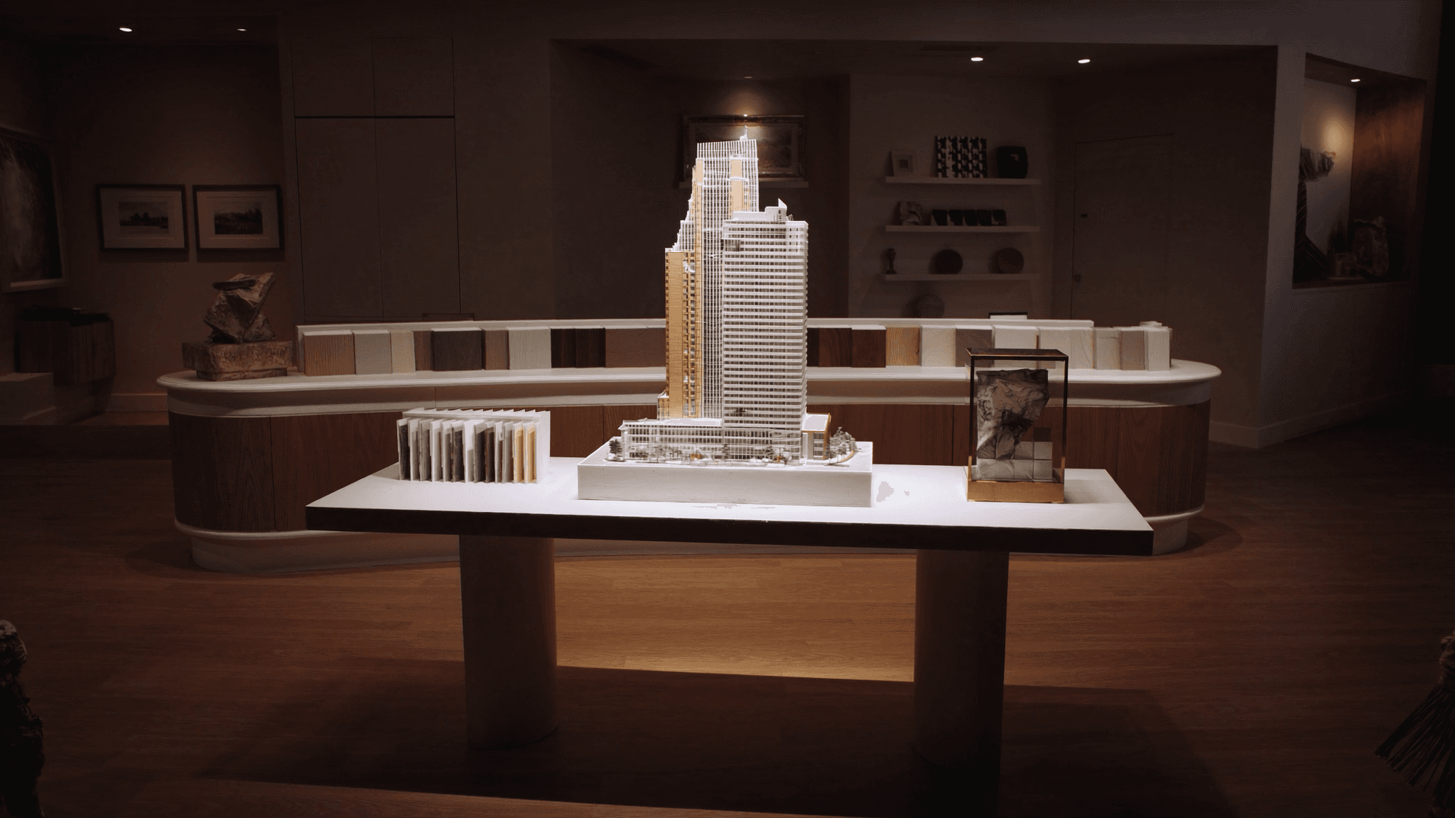 High-end Chicago real-estate presale gallery with architectural scale model and material samples