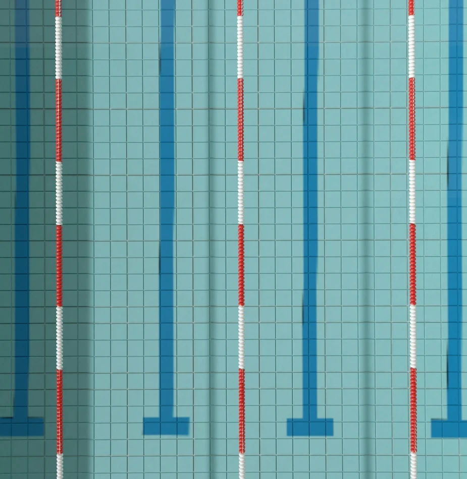 Swimming pool lane markers with red and white lane dividers against turquoise tiled pool floor, representing precision in aquatic environments.