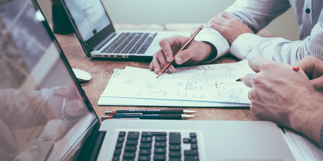 Two people calculating costs for their business