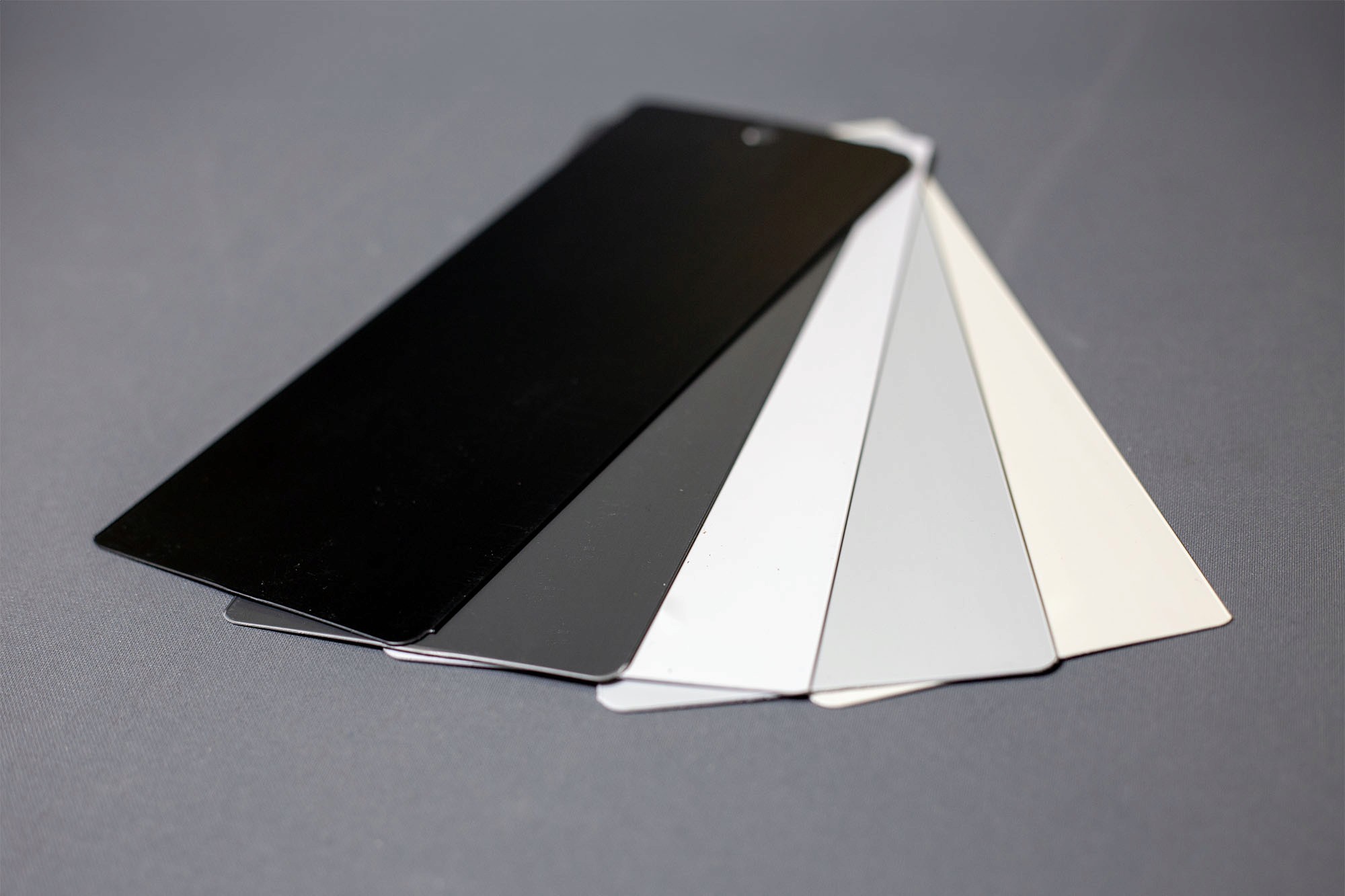 Two people sit across a table in a stylish room with red velvet walls and a large red pendant light. The mood is intimate and modern.