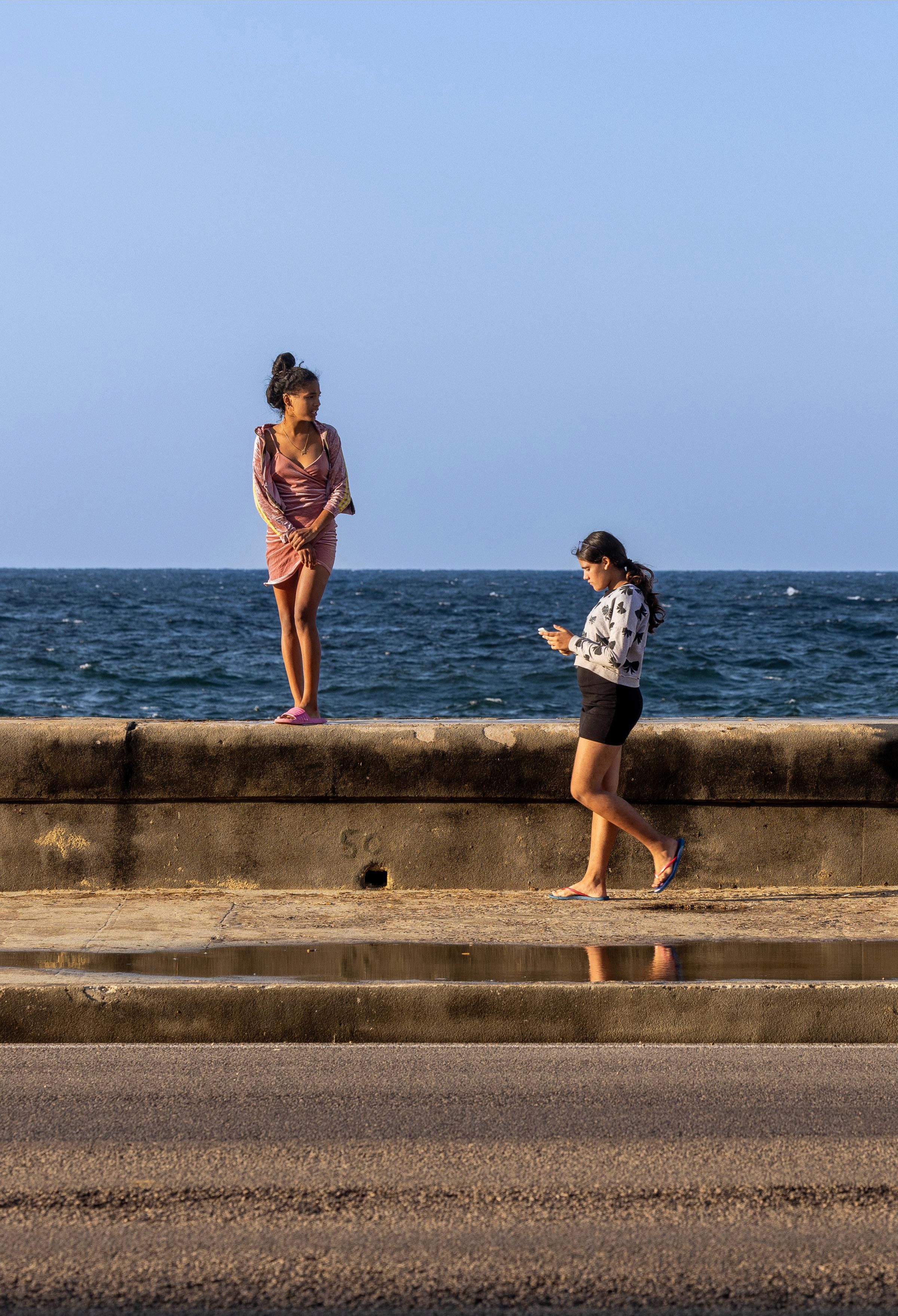 Young girls out for a stroll on the Malecón—a popular place for tourists and locals alike.