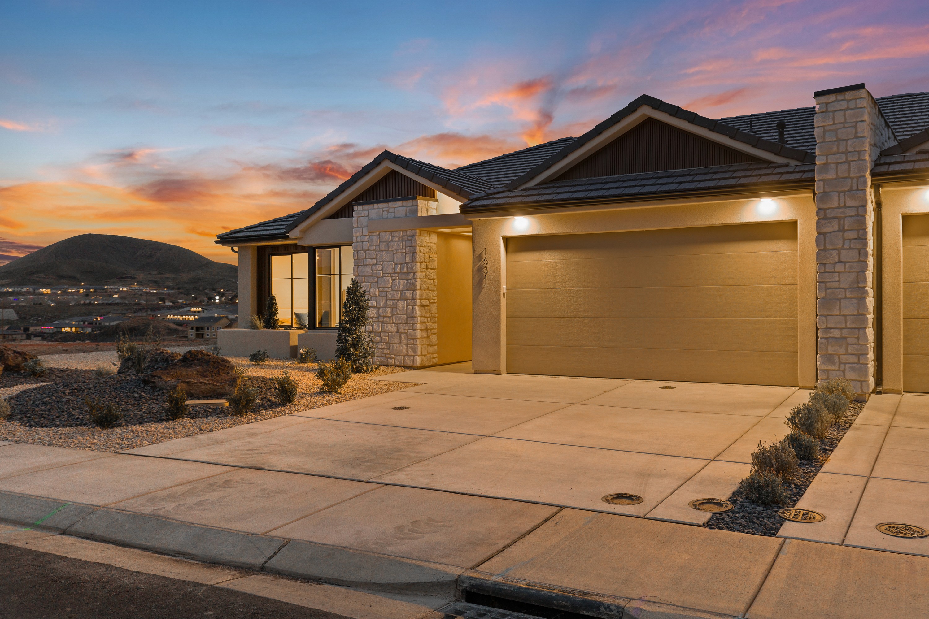 Twilight exterior of The Painted Horizon twin home in Hurricane, Utah showing the home’s architectural details and warm evening lighting.