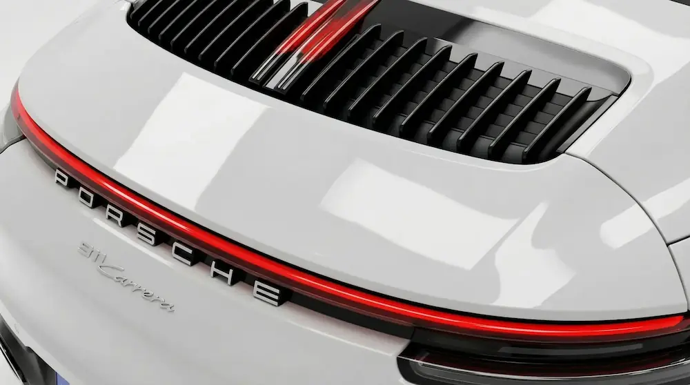 Vue arrière d’une Porsche 911 Carrera blanche après detailing, finition nette et plastiques noirs ravivés.