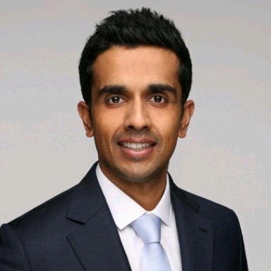 a man in a blue suit posing for a picture