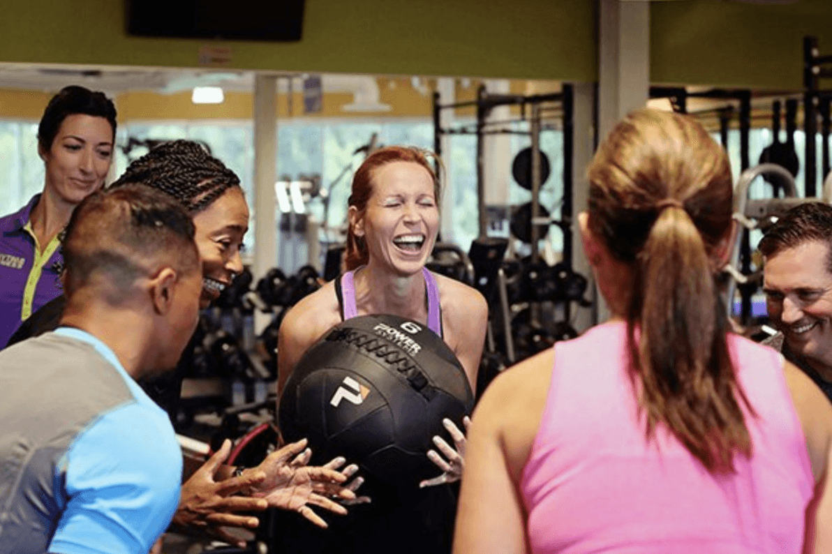 A group of men standing around each other in a room