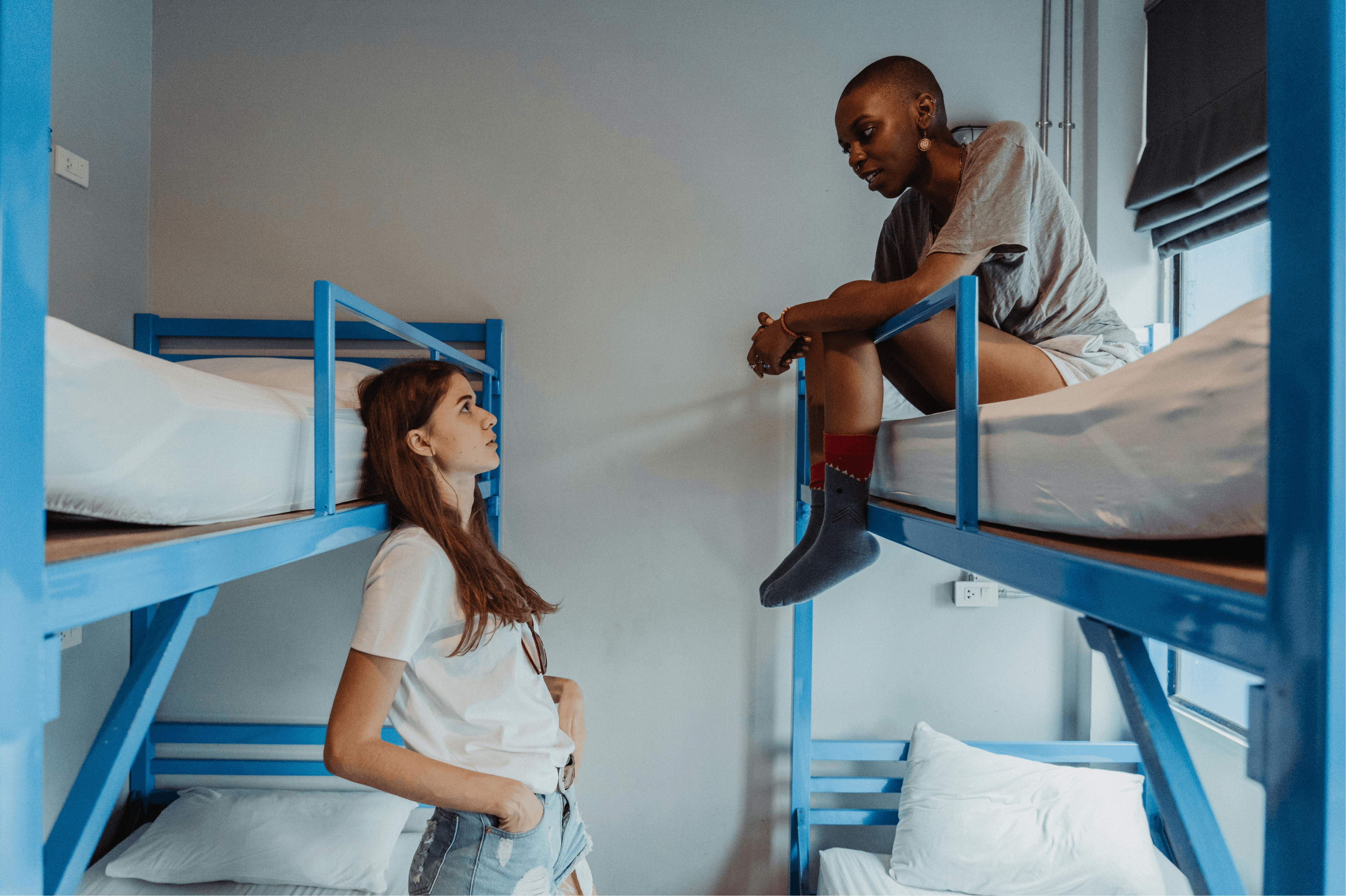 two young girls in a hostel room