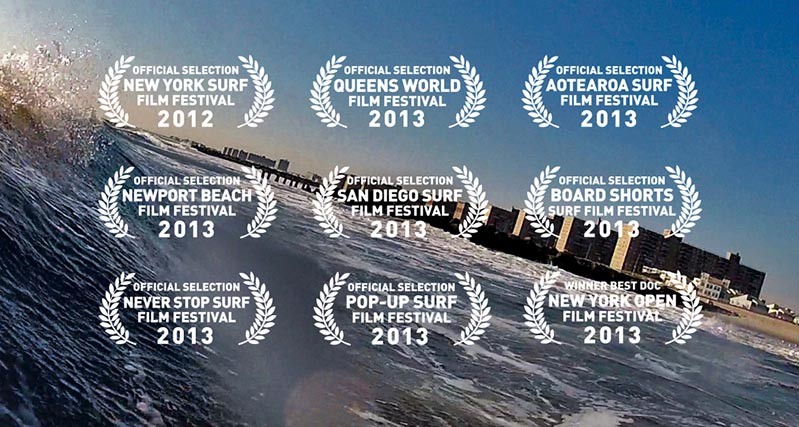 A photo of a sea wave near a city scape. Over the photo there are some surf film festival awards.