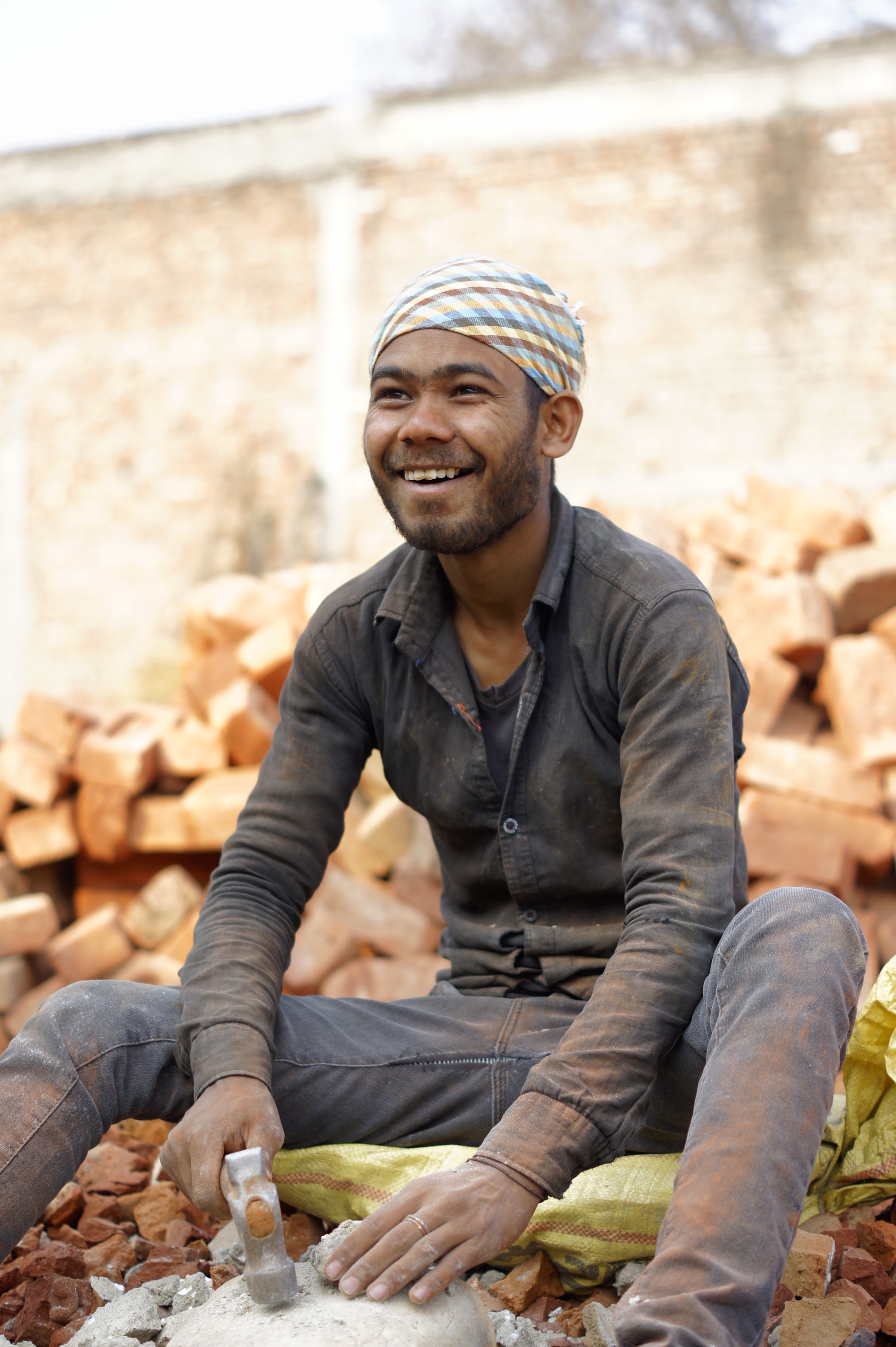 A smiling worker on a GreenJams construction site