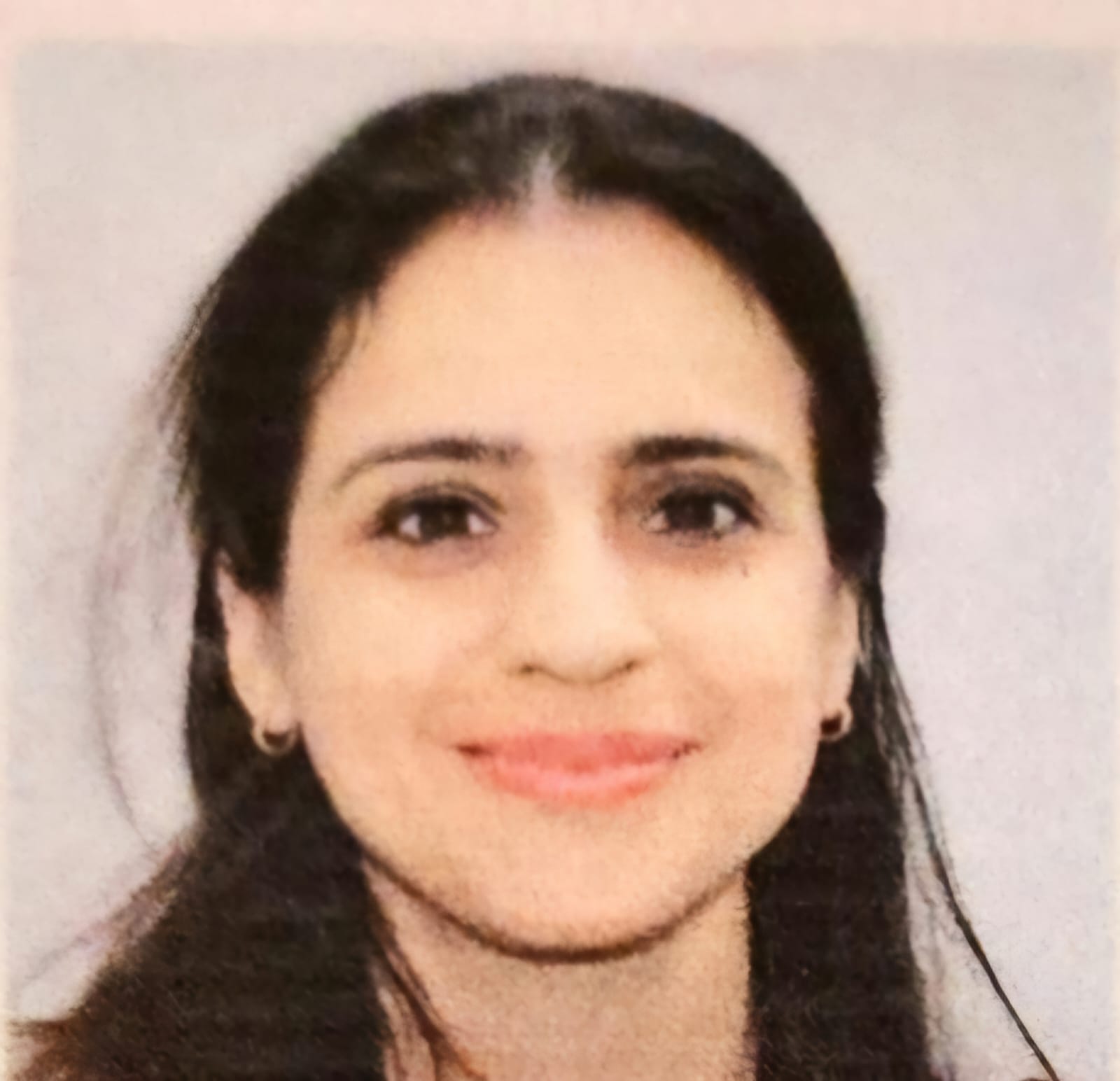 Minimalist profile shot of a man with long braids and a white shirt, set against a soft, light background.