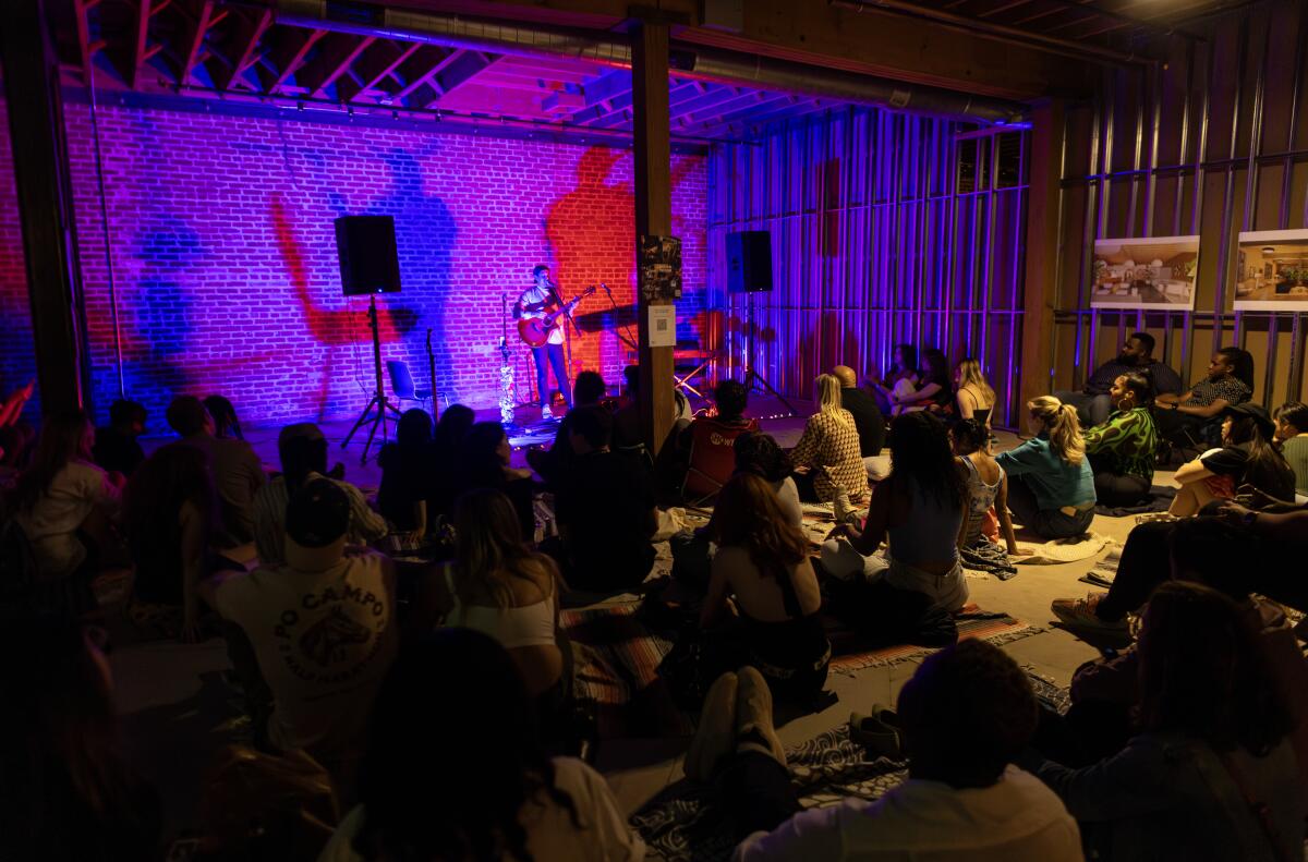 crowd of people sitting on chairs inside room