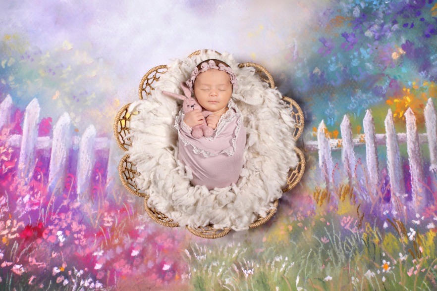 A sleeping newborn baby wrapped in pink