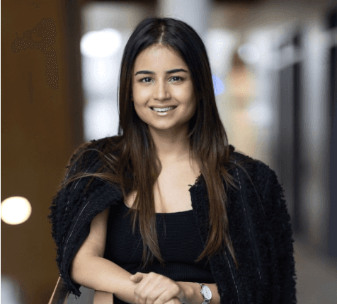Close-up of lush, dark green leaves, some glossy and wet, against a muted background.