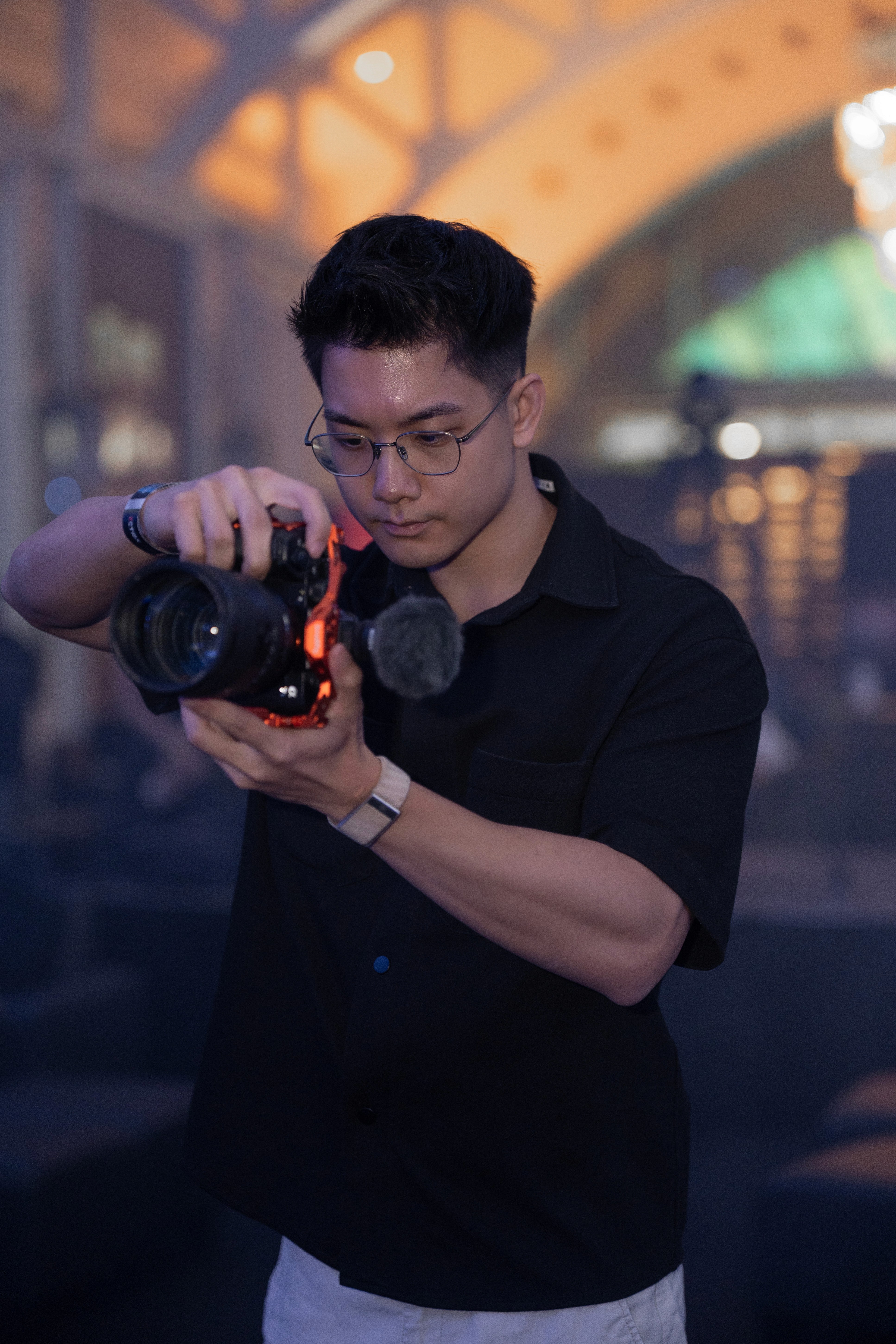 man with glasses smiling fully 