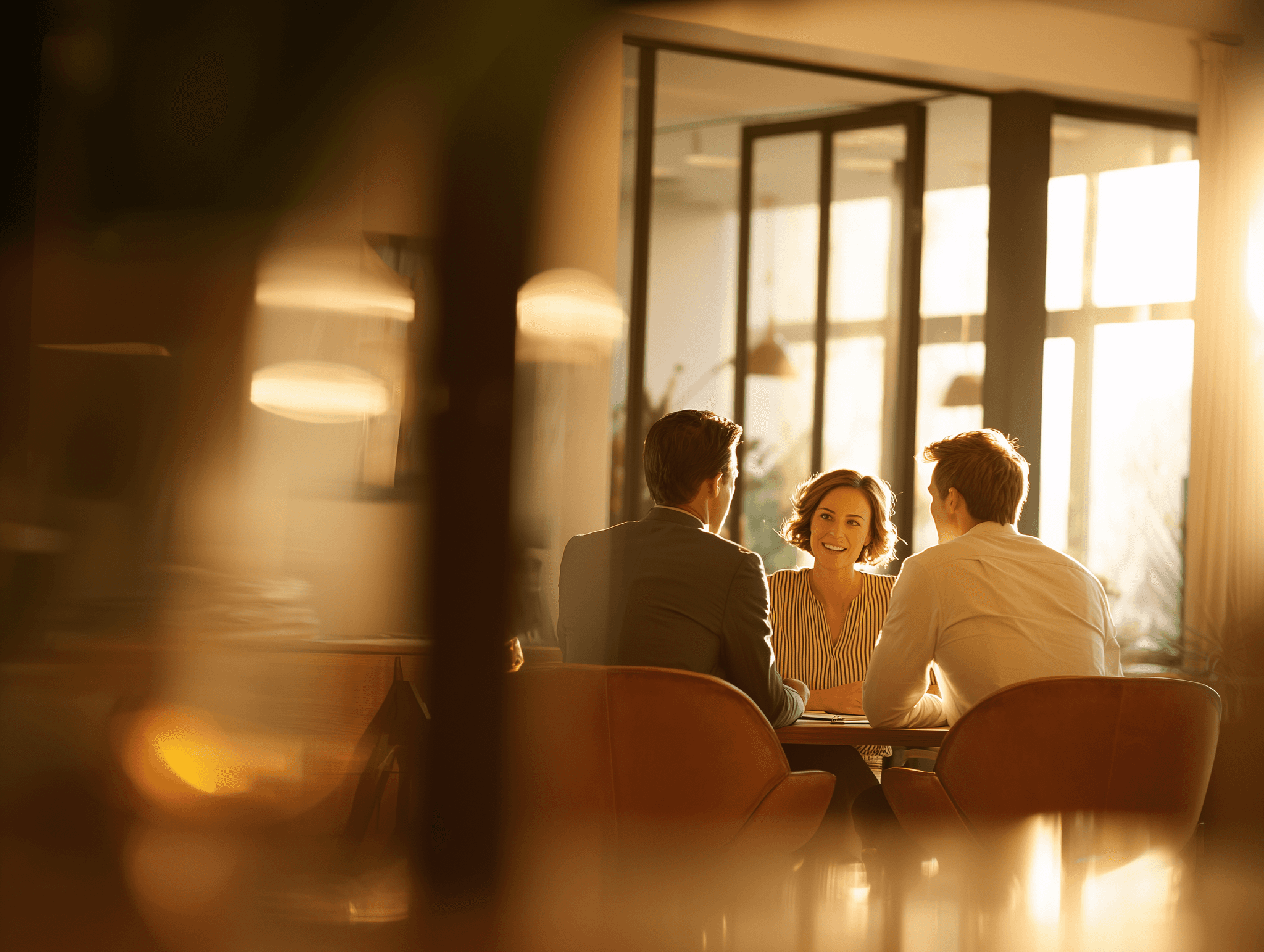 A couple talking at a desk in a bright office