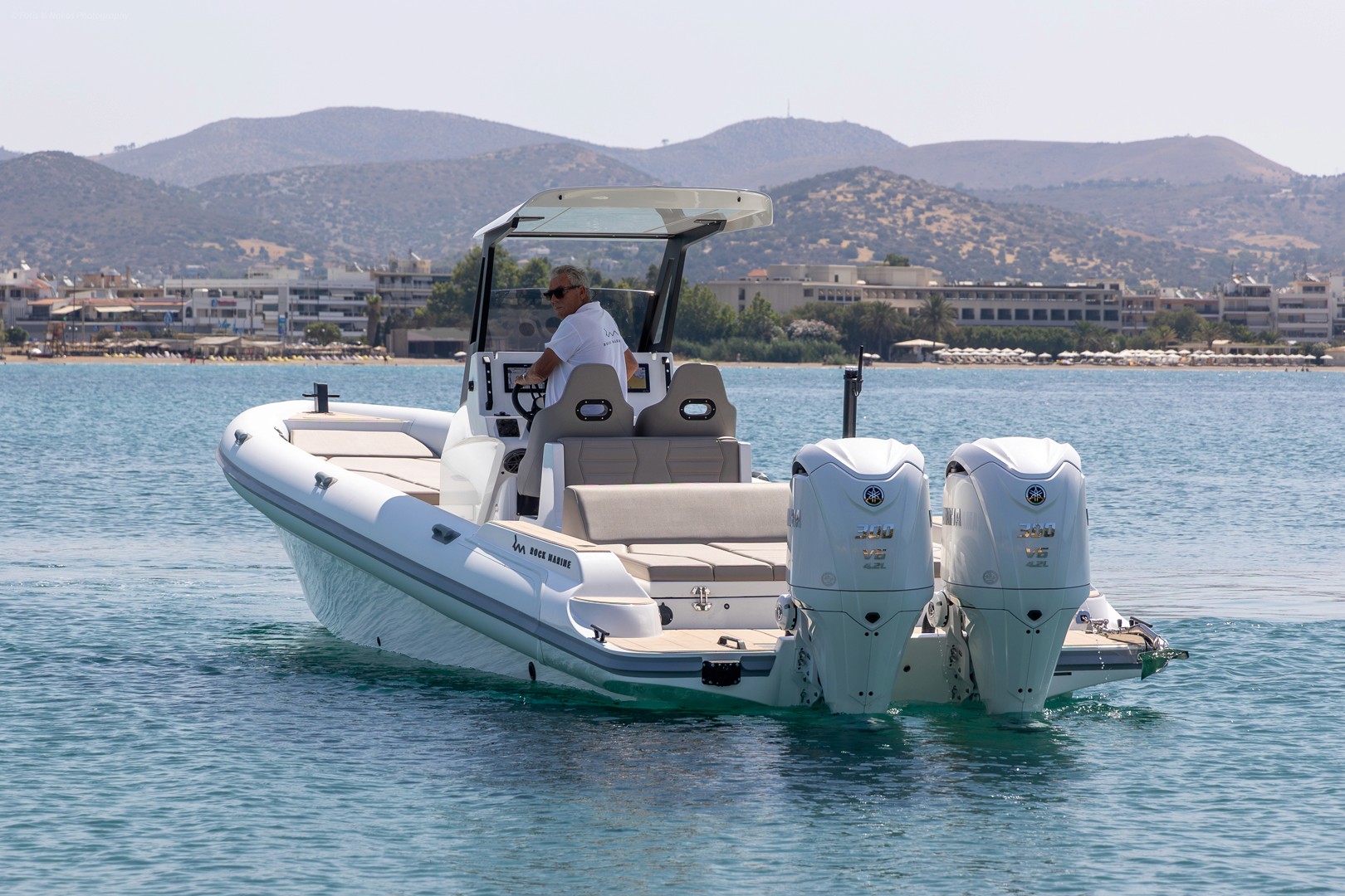 Luxury captain's chairs on the Rock 36 Naboo yacht deck with calm blue waters and Greek islands in the background.
