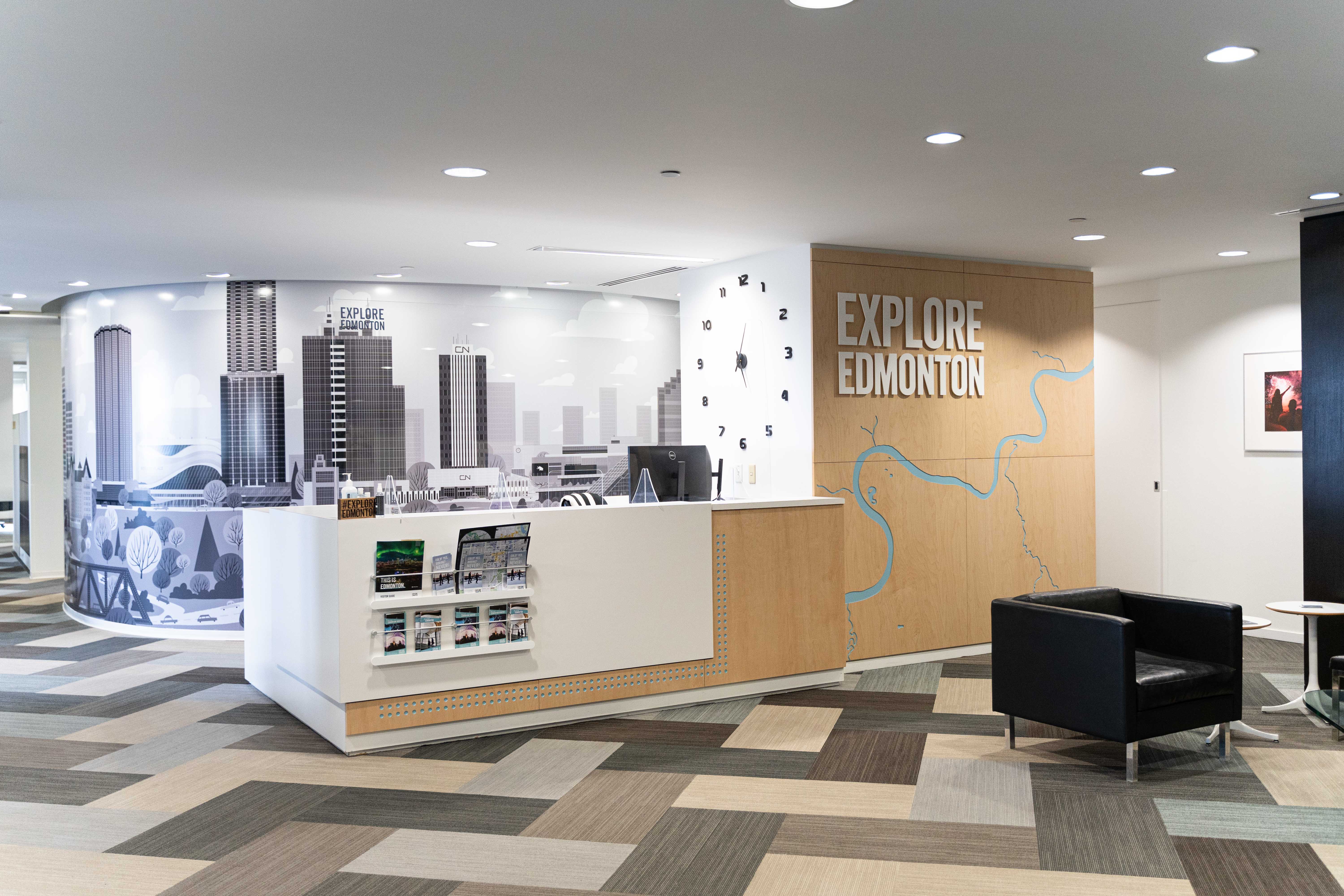 Explore Edmonton reception area with a custom milled feature wall that has the north saskatchewan river going through it.