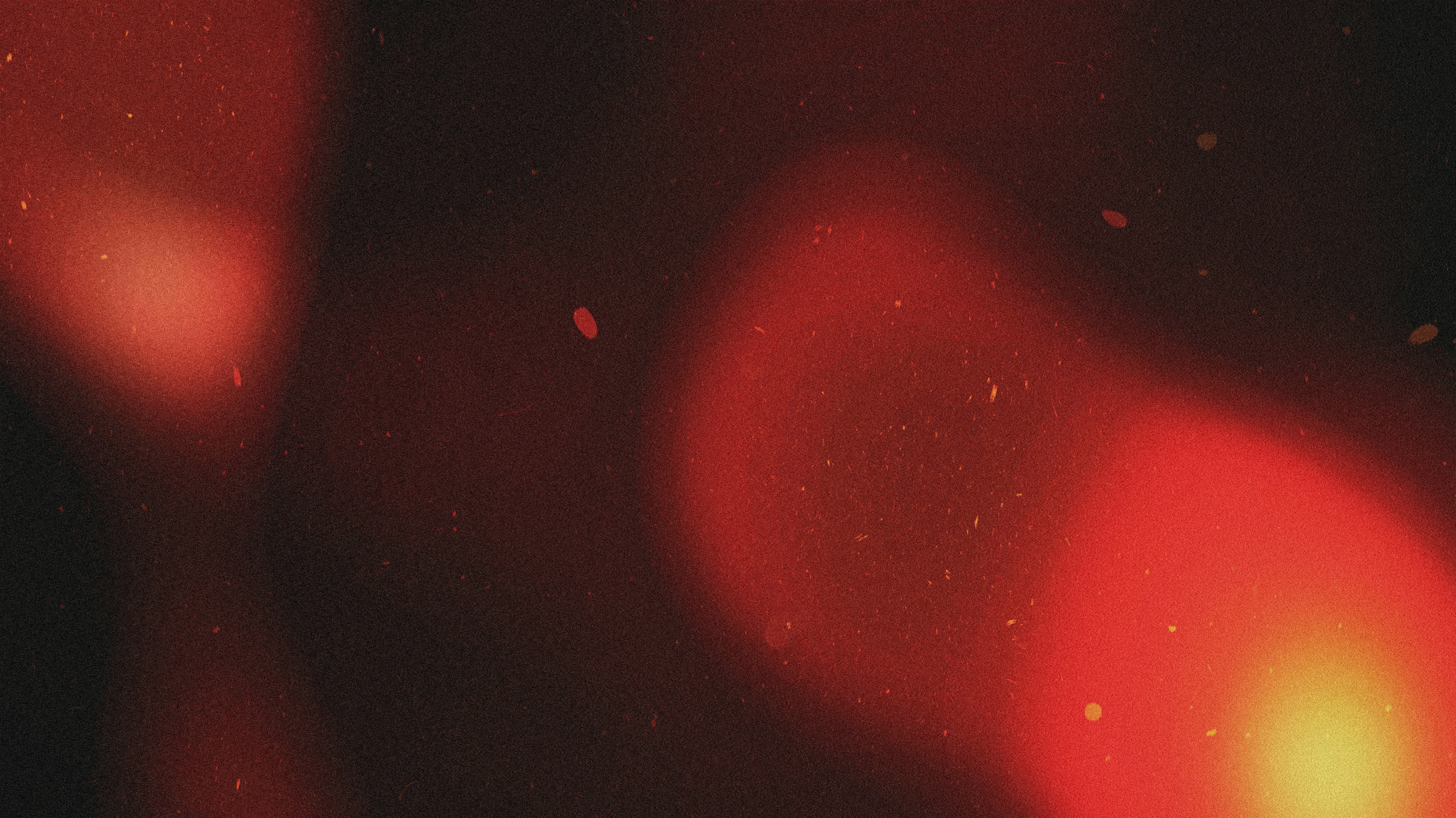 Abstract red and orange light flares with dust particles.