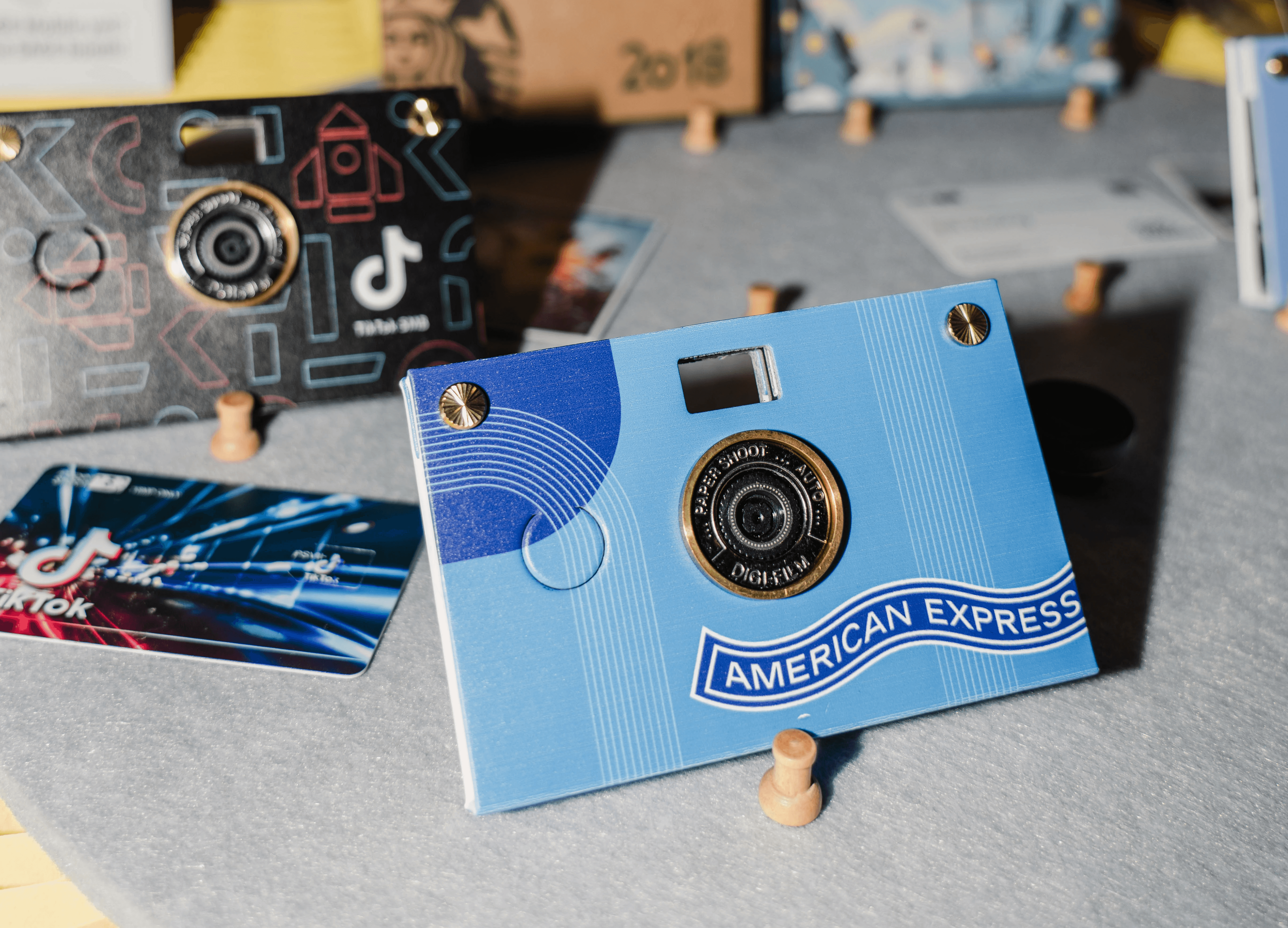 Multiple papershoot cameras taken with flash photography, that are branded for multiple brands such as tiktok.