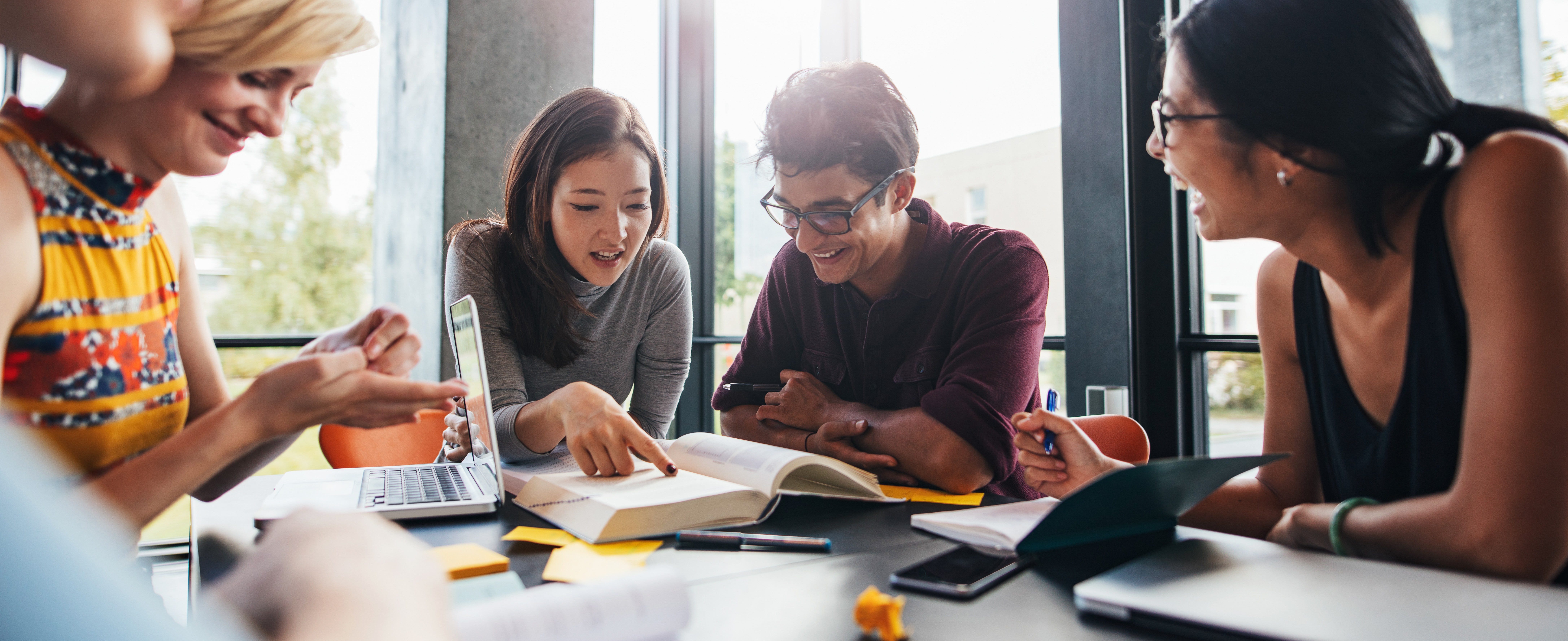 University students doing group study in library - AdobeStock_376858486