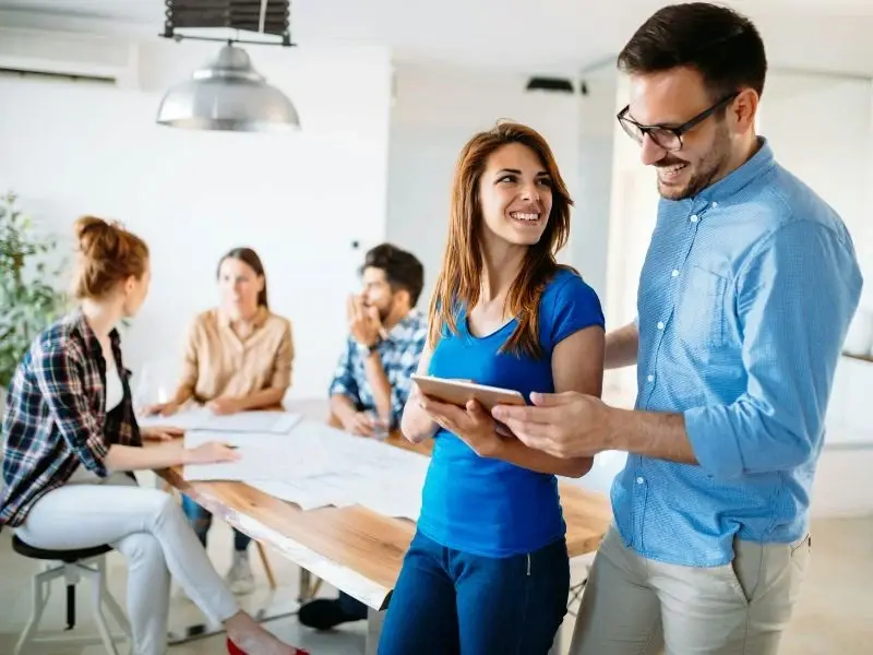 Image of employees discussing over documents after coming back from break