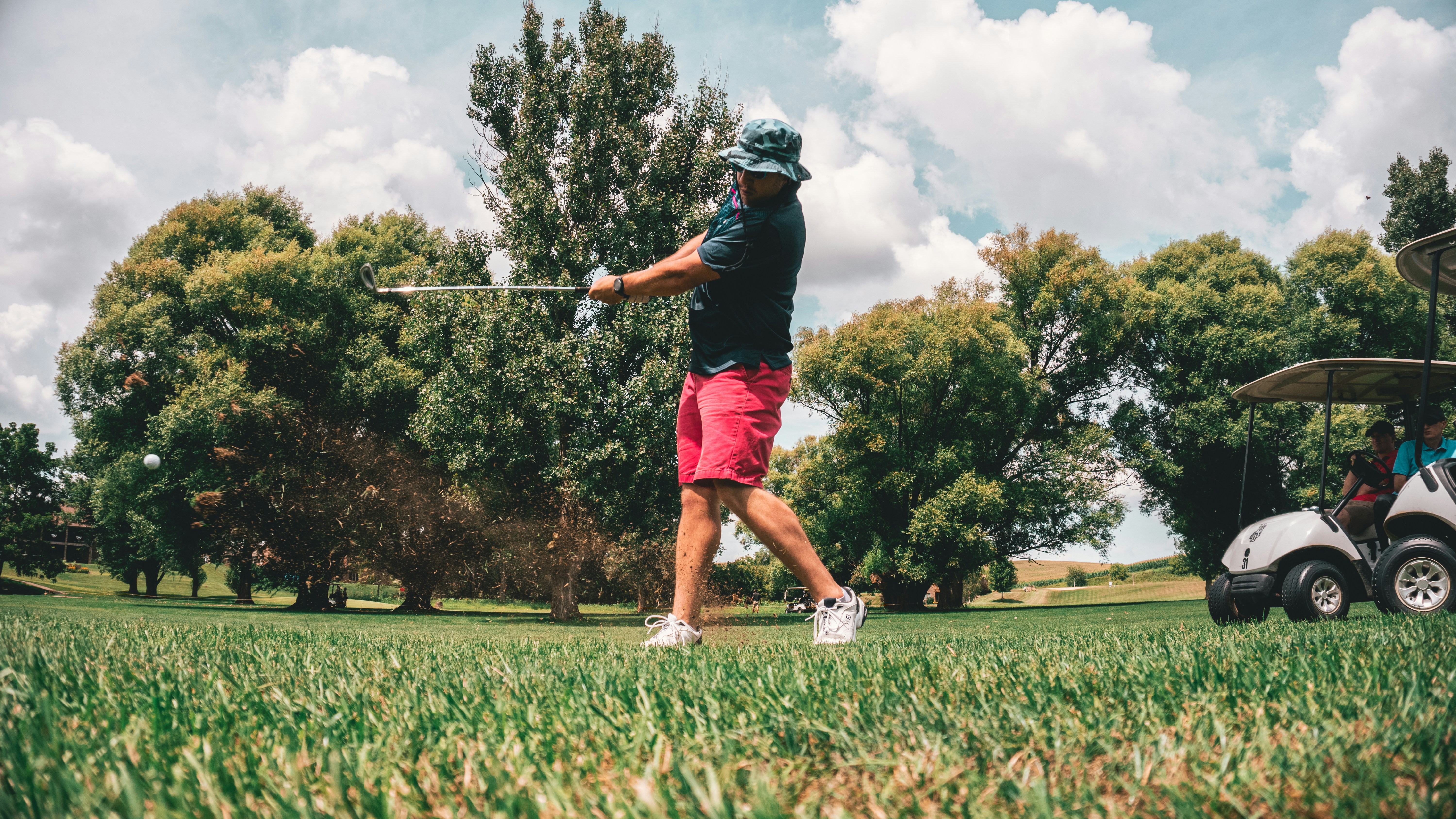 man swinging his golf stick - Fall golf outfits