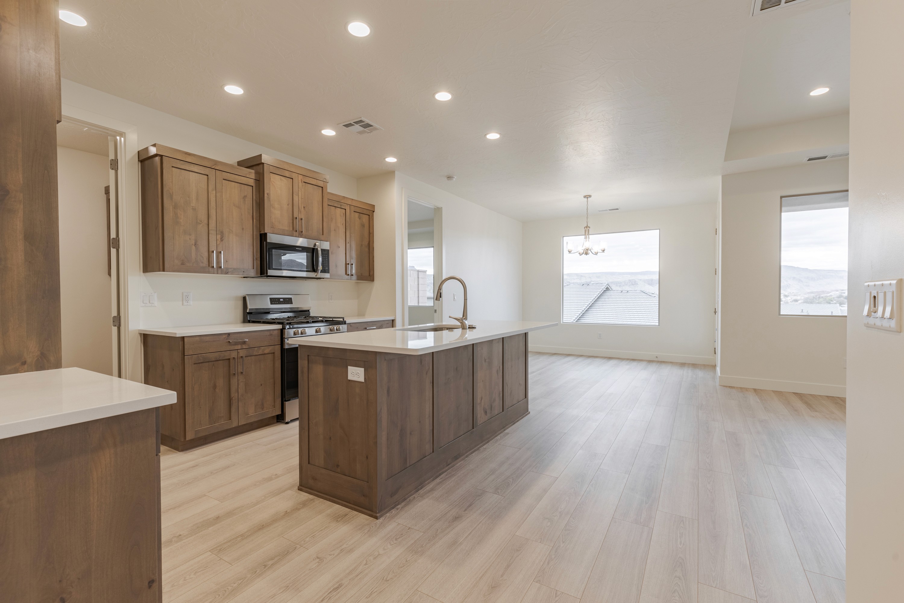 Kitchen inside the Painted Sands twin home in Hurricane, Utah featuring cabinetry, countertops, and functional layout.