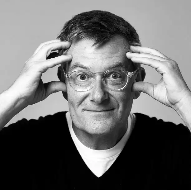 Woman working at desk with laptop and phone.