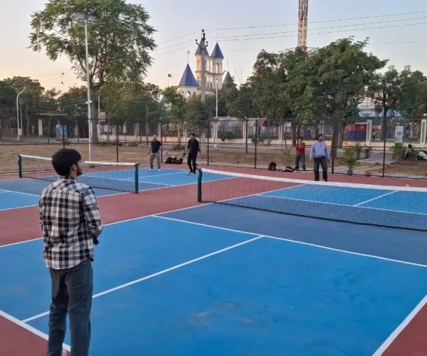 Modern orange lounge chair beside white coffee table.