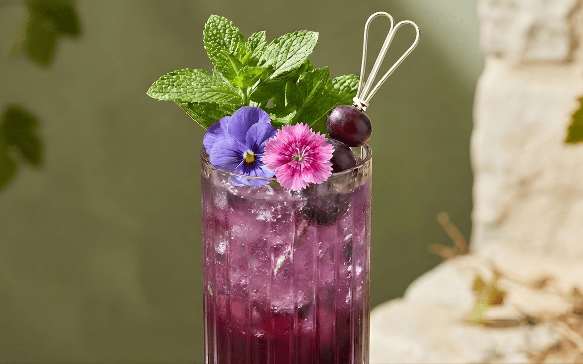 Modern kitchen with dining area overlooking the ocean. Large windows and sliding doors offer stunning coastal views.