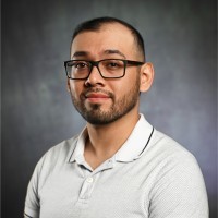 gold and black bottle on white wooden table