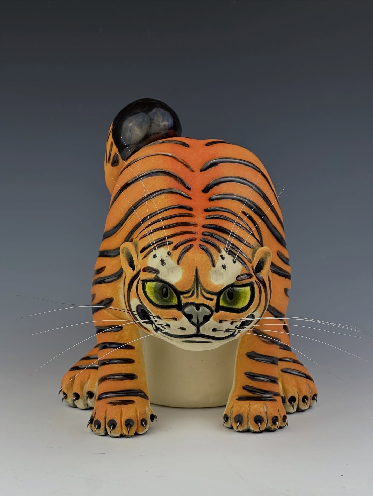 Young woman in colorful robe reads a book.