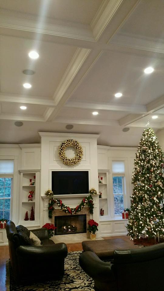 Living room renovation with coffered ceiling, custom built-ins, and fireplace feature wall