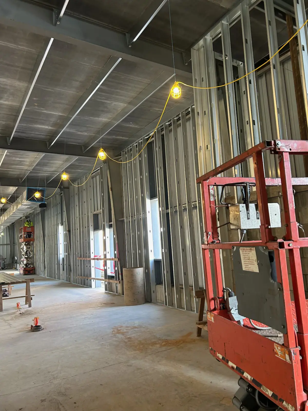selective focus photography of two men standing side by side wearing green reflective vests
