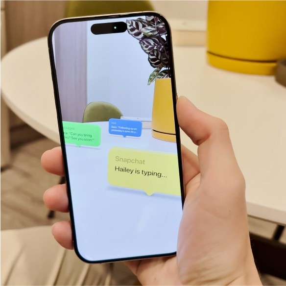 A photo of a phone with an AR view of colorful bubbles on a table