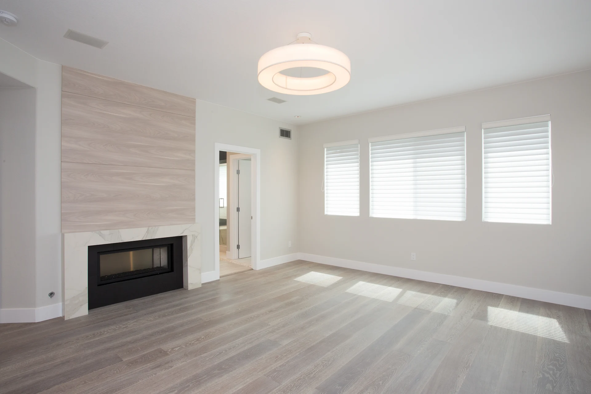Full view from angle 1 of the master bedroom, showcasing the open space and elegant design in this modern Newport Beach home.